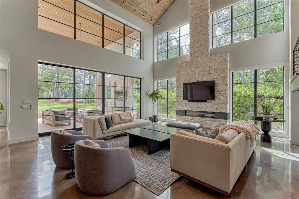Spacious great room with vaulted Alder wood ceilings and expansive windows offering golf course views