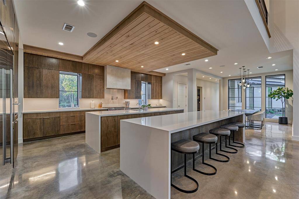 Chef’s kitchen with Wolf/Sub-Zero appliances, dual islands, and custom white oak cabinetry