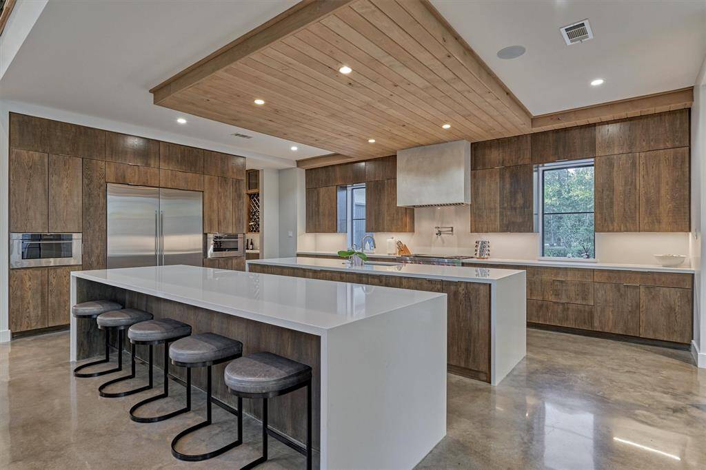 Clean, modern lines with flat-panel cabinetry and integrated appliances for a seamless look
