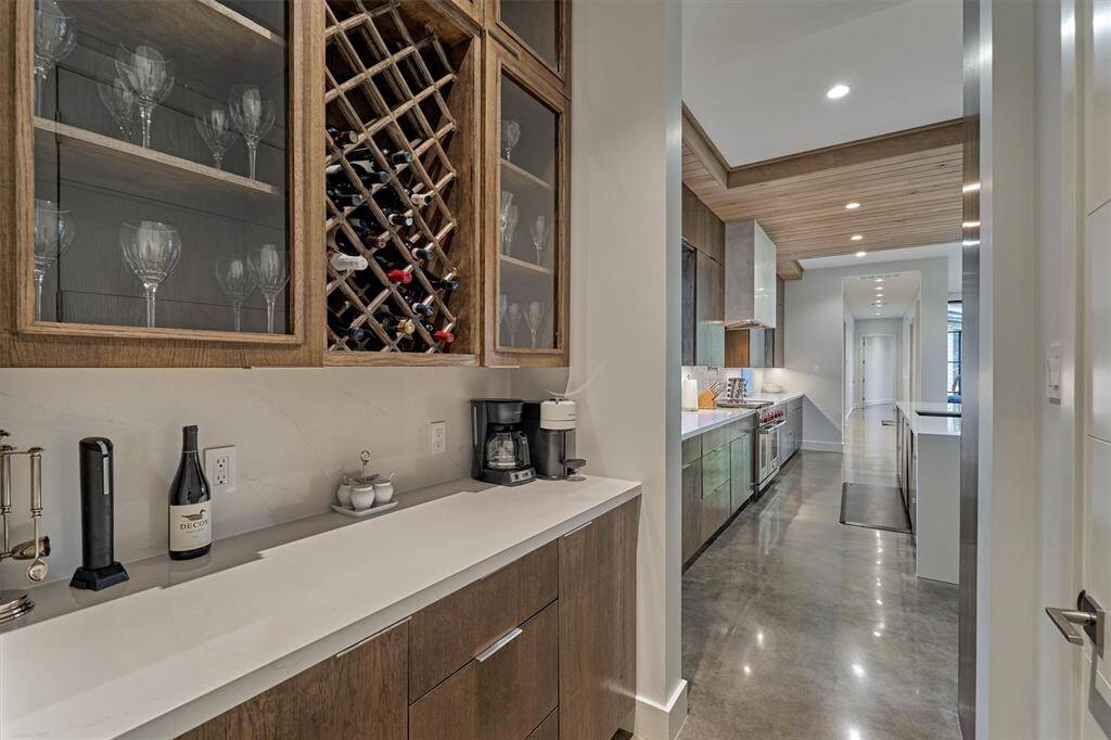 Bar area with modern glass enclosure, offering style and functionality