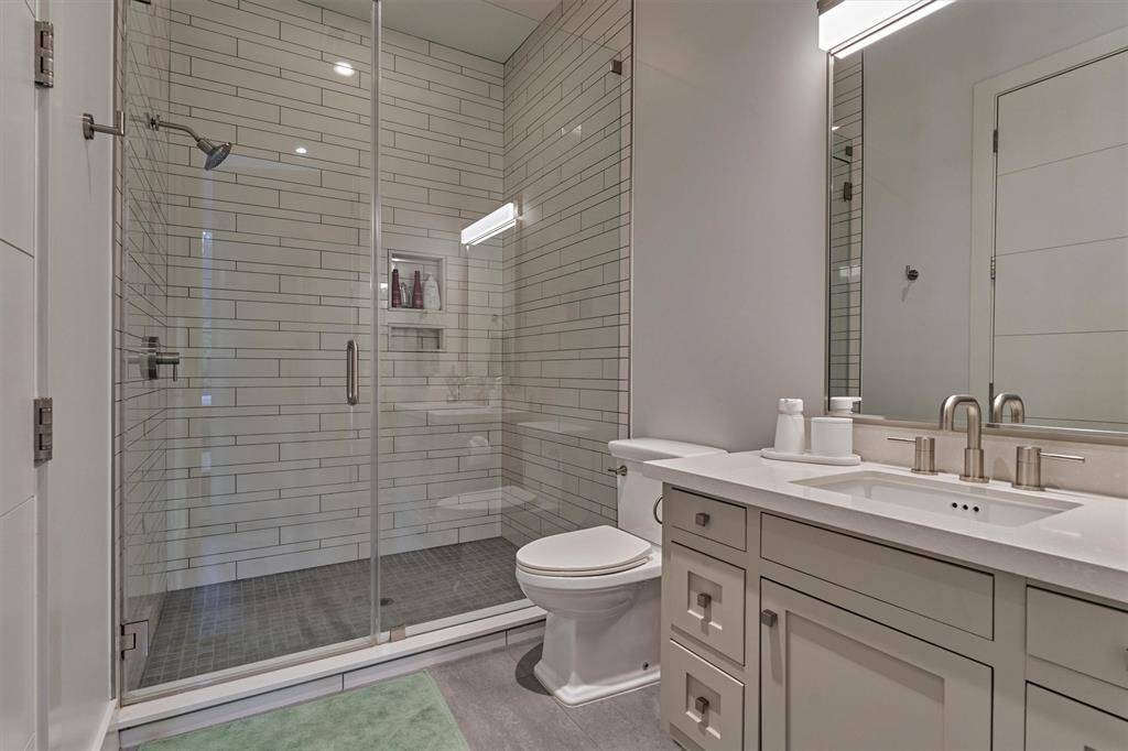 Well-appointed full bathroom with premium fixtures and direct access from the secondary bedroom