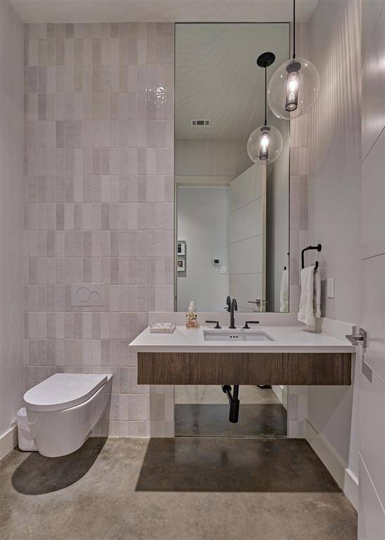 Stylish powder bath near main living areas with sleek hardware and curated lighting