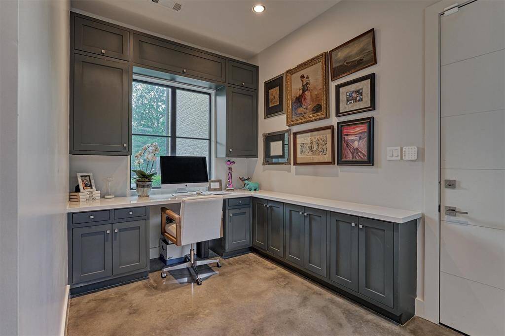 Bright and functional secondary office space featuring abundant natural light and sleek modern built-in cabinetry—perfect for focused work in a beautifully designed setting.