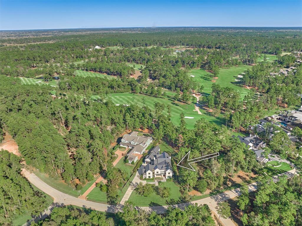 Breathtaking view of the home’s position just behind the 14th green with lush landscaping and golf views
