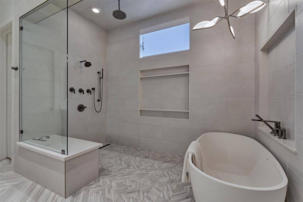 Luxury primary bath with expansive open shower and soaking tub