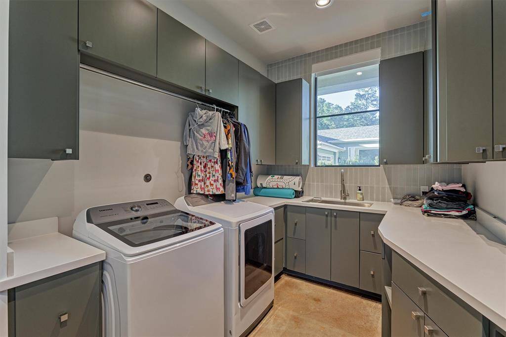 Spacious and practical laundry room with direct laundry chute access from the master closet