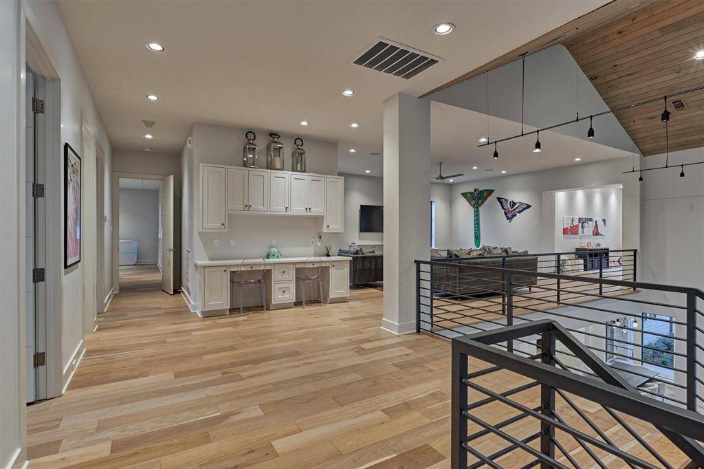 Functional landing with built-in workspace and storage, opening into a flexible upstairs living space