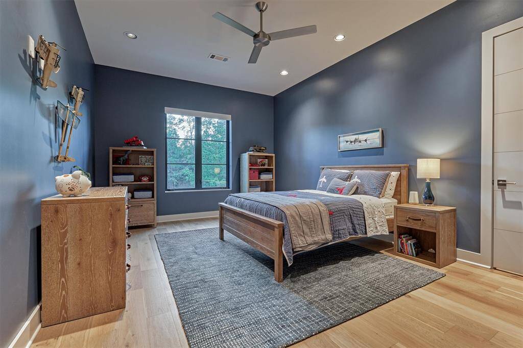 Comfortable upstairs bedroom with clean modern finishes and access to shared bath