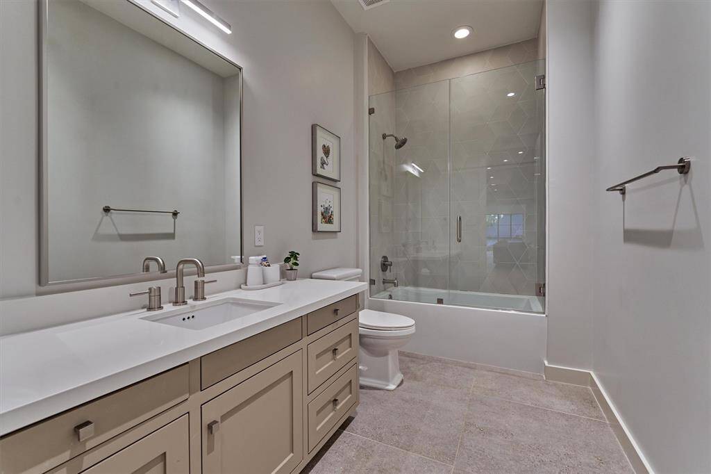 Shared full bath with hallway access, connecting two spacious secondary bedrooms