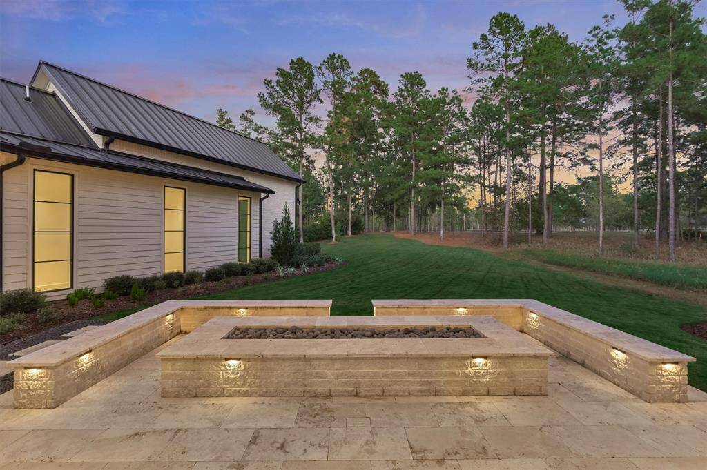 Cozy gas fire pit area ideal for evening gatherings overlooking the backyard