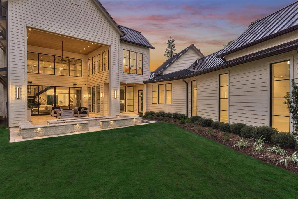 Expansive backyard with Seville travertine patio, summer kitchen, and seamless transition to indoor spaces