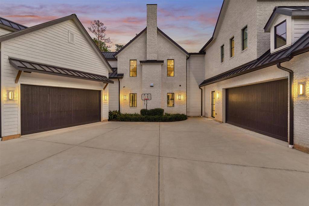 Spacious 4-car garage and motor court offer ample parking with clean, modern exterior finishes