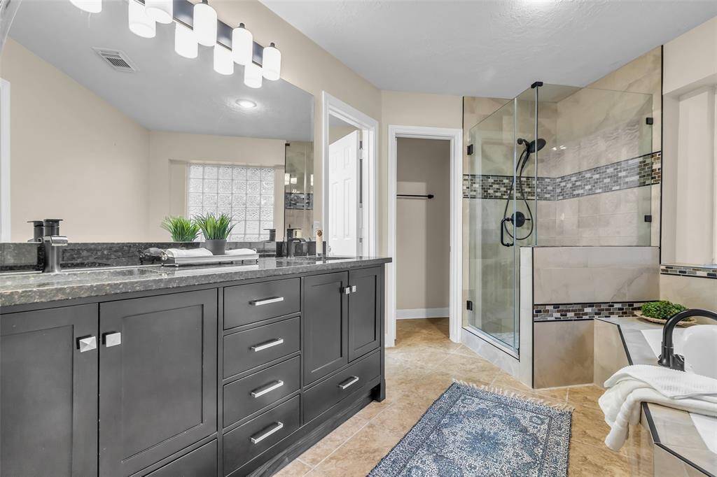 Luxurious Primary ensuite bath complete with large walk-in shower and double sink vanity.