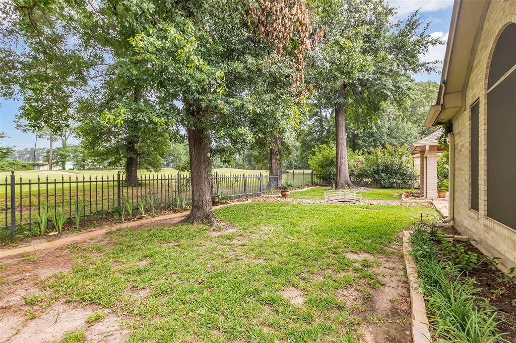 View of side yard.  Lots of mature trees.