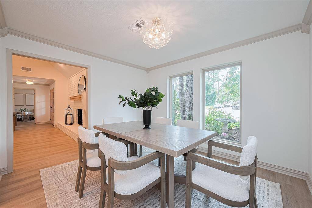 Stunning formal dining room has an open feel, beautiful lighting and large brand-new windows throughout the entire home.