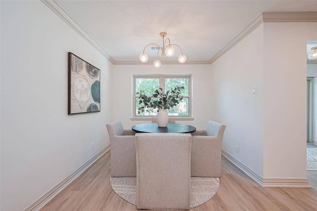 Such a lovely breakfast area is a convenient space open to kitchen and living room. The brand-new windows, paint colors, flooring and lighting all are what makes this home move in ready for any new homeowner.