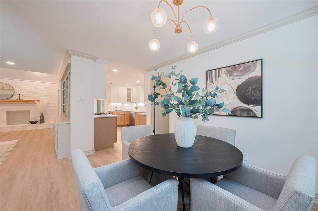 How convenient is this breakfast area with lovely lighting, open to the kitchen and living area. This area can be used for many things. Play area for children, wine bar, whatever you desire. Large windows bring in tons of natural light and the beautifully landscaped backyard patio into view.