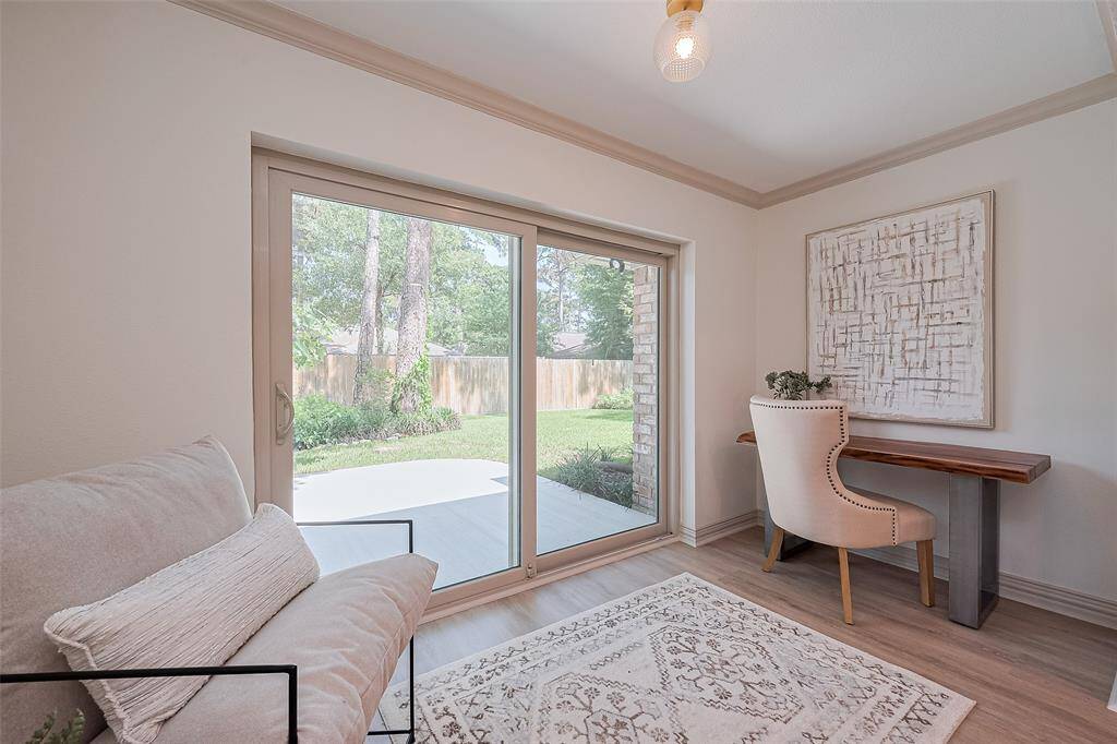 Another view of the home office, reading, or play area. Beautiful new sliding/screened door provides access to the back yard patio, allows fresh air and tons of natural light to filter throughout the home.
