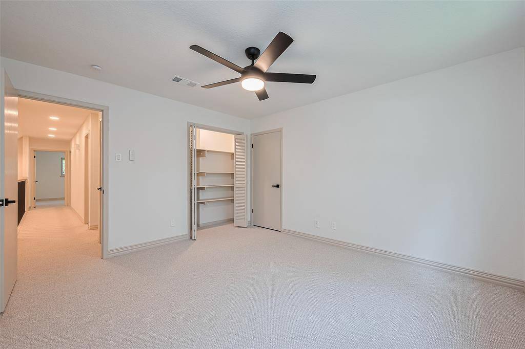 Upstairs 1st of 3 bedrooms, brand new soft neutral carpet and paint, brand new energy efficient windows, ceiling fan, and a closet with shelving.