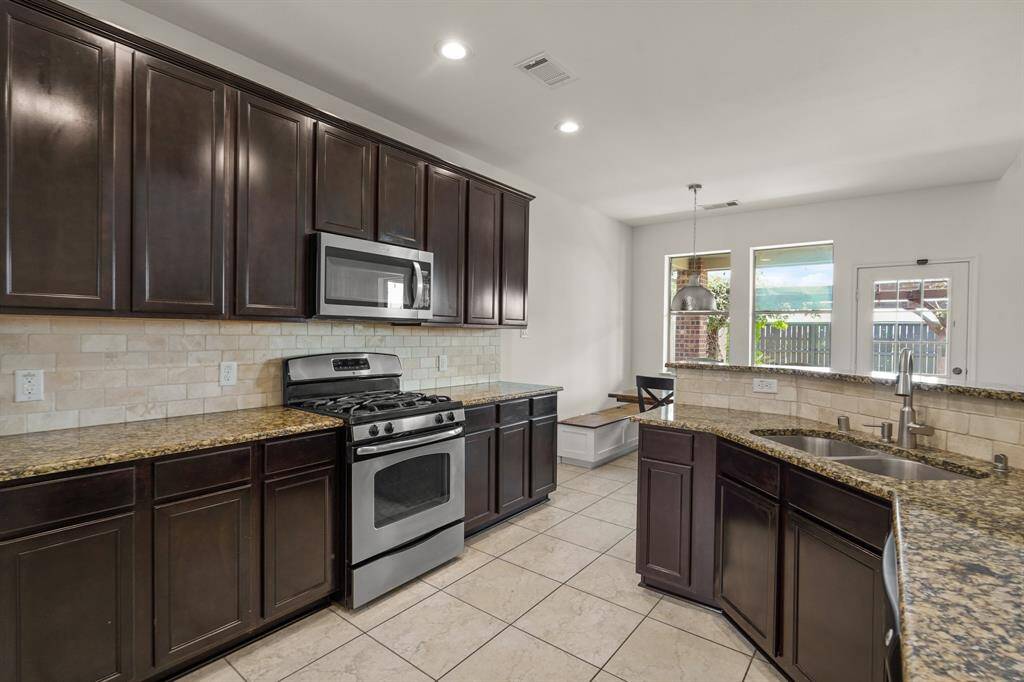 The heart of the home! This stunning chef’s kitchen features elegant cabinetry, sleek stainless steel appliances, and granite countertops—perfect for gathering and entertaining.