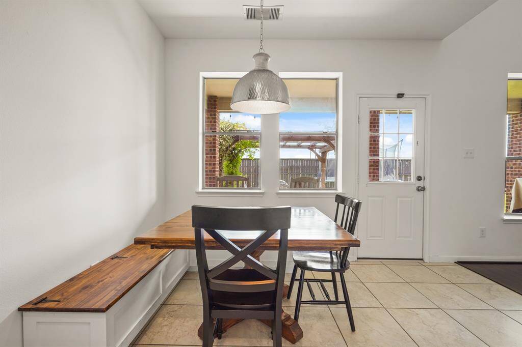 Start your day off right with a cup of coffee sitting with your family in the breakfast area! Featuring large windows, neutral paint, a modern chandelier, and access to the covered back patio! *This room has been virtually staged
