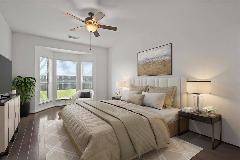 The primary bedroom welcomes you with bright natural light, an upgraded bay window with a relaxing sitting area, and the perfect view of the serene yard. It sits at the back of the home offering additional privacy and easily fits a king size bed plus furniture!  *This room has been virtually staged