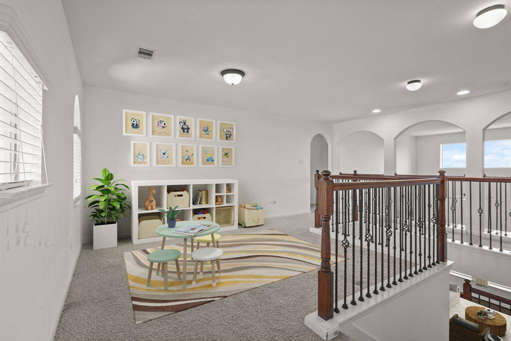 Upstairs you walk into a large game room that's perfect for a play room, pool table, or lounging space! This spacious game room features plush carpet, bright natural light, and plenty of space—perfect for movie nights, game days, or just hanging out. *This room has been virtually staged