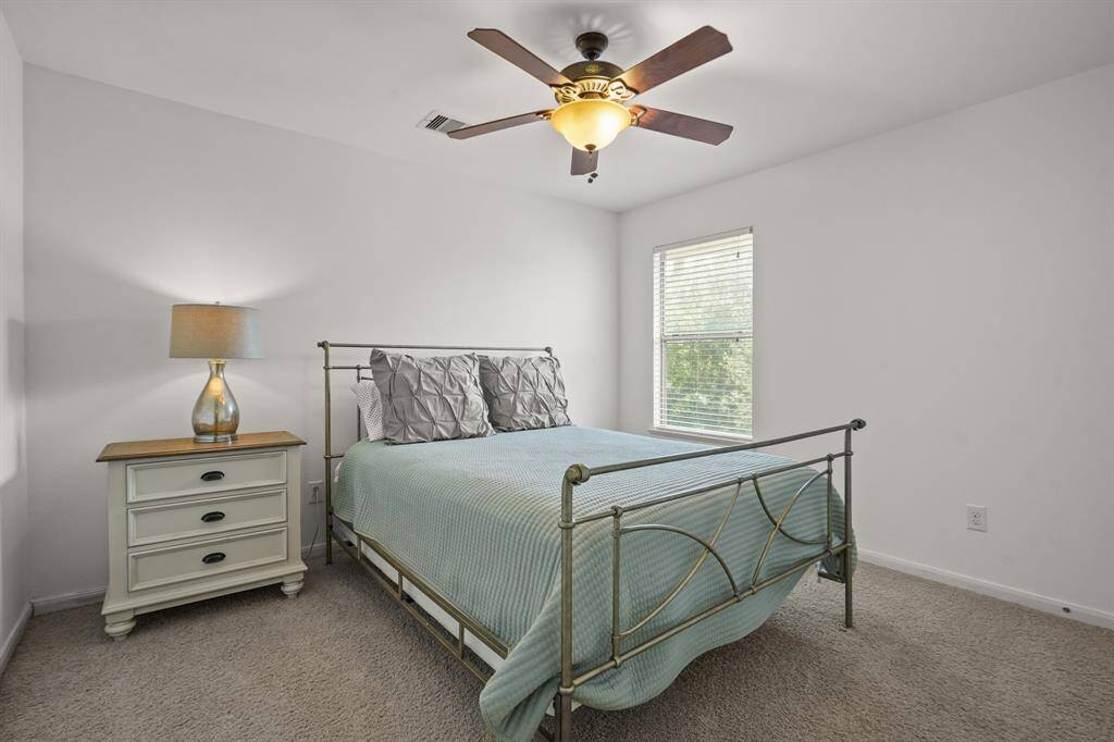 Bright and inviting, this spacious secondary bedroom offers plenty of room for relaxation and personalization, making it the perfect retreat for family or guests.