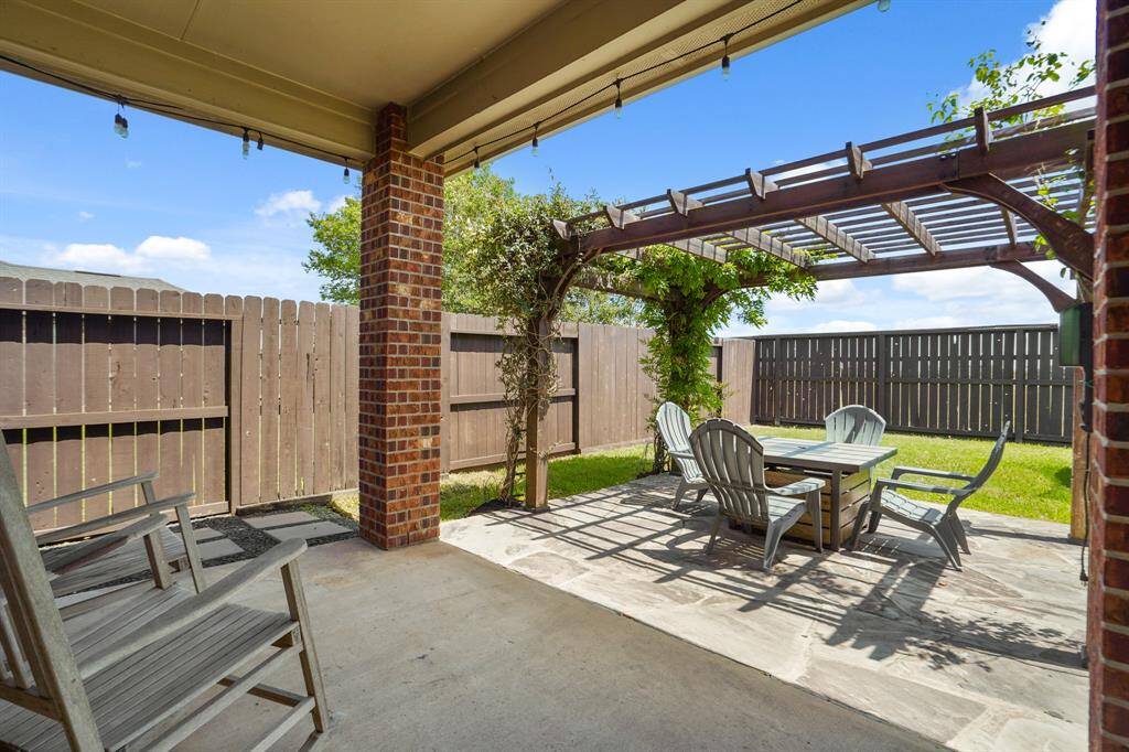 Step outside to enjoy the expansive backyard, complete with a covered patio, extended concrete area, and pergola — the perfect setup for outdoor dining, lounging, or weekend barbecues.