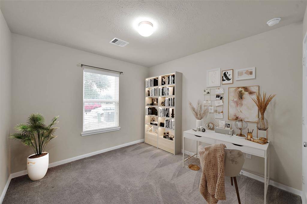 Front bedroom virtually stage as an office.