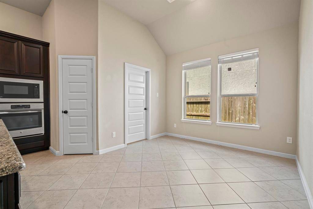 A bright and inviting breakfast nook with ample natural light, perfect for morning coffee or casual dining.