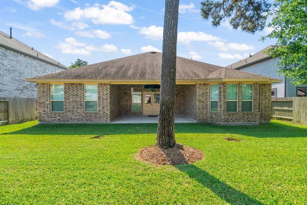 Enjoy the inviting covered patio overlooking the spacious backyard.
