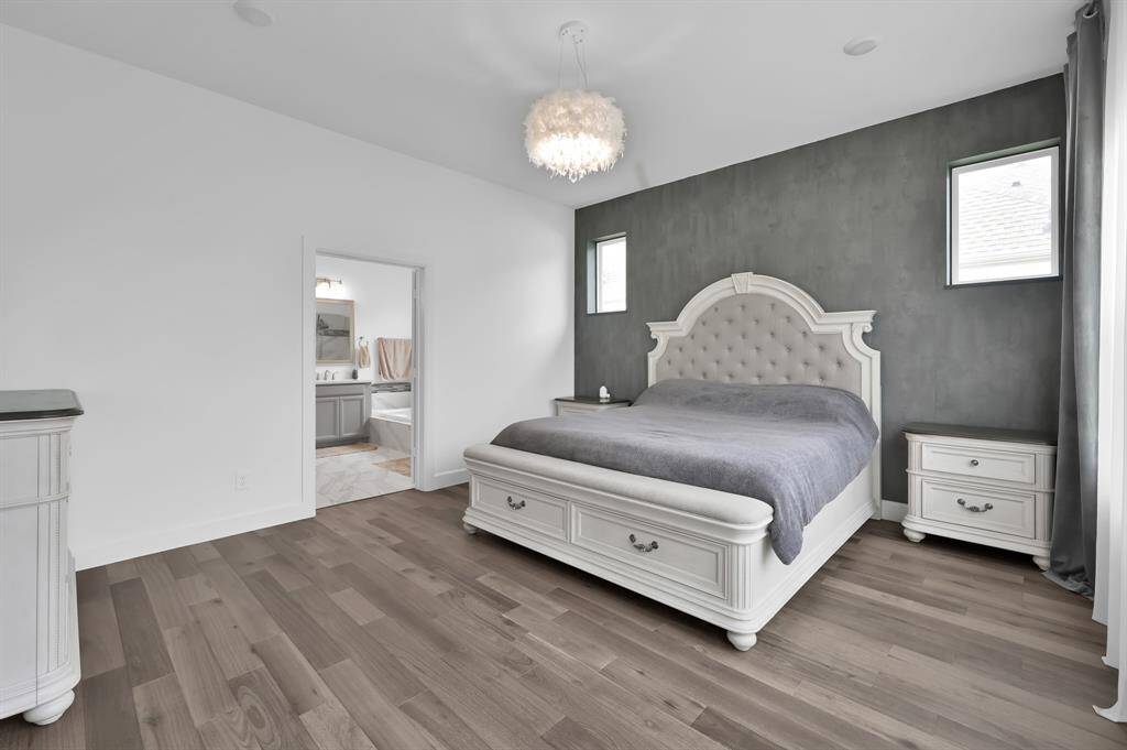 Primary suite with accent wall LVP flooring.