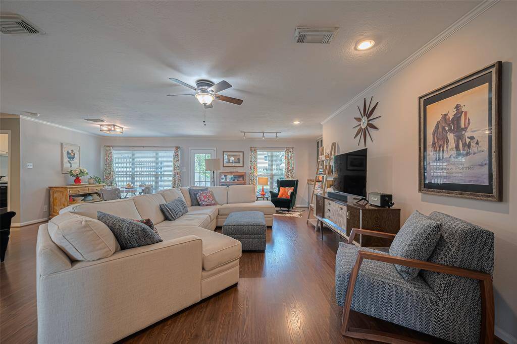 The crown molding adds so much charm and the lighting gives options to set the mood. Love the small space with winged chair and orange lamp for sitting with a good book - so many unique spaces!