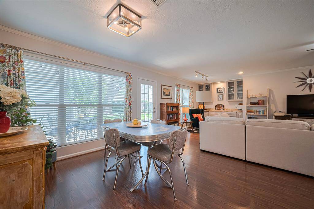 Love this quaint breakfast area with all the natural light and gleaming laminate wood floors
