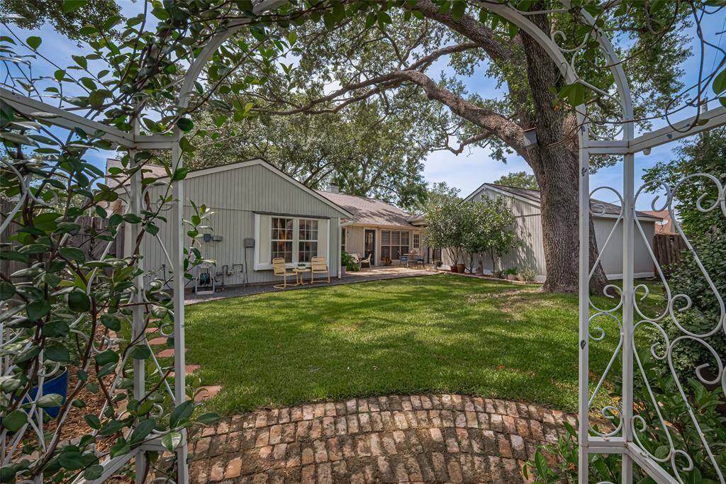 Perfect view from the trellis to the manicured landscaping and mature shade tree. The double garage has storage and new electrical panel