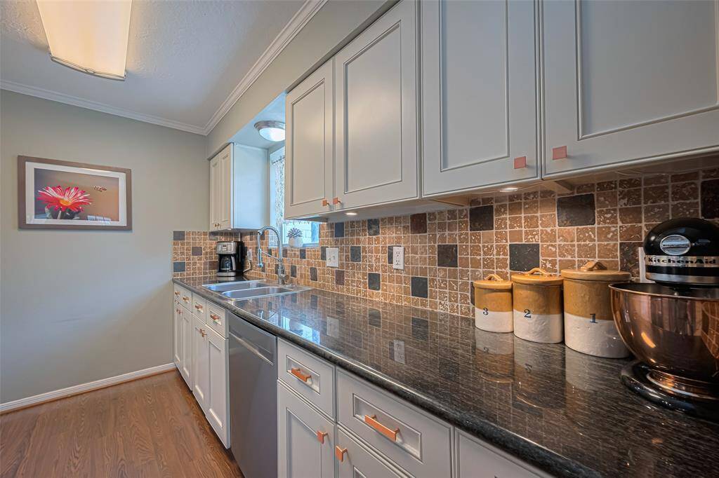 Lots of prep space with your granite countertops. Great gold feature hardware with the refreshed painted cabinets