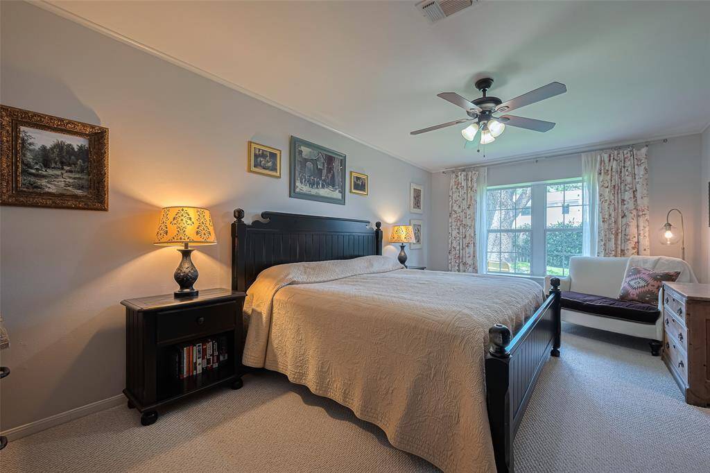 The Primary suite has warm tones with neutral berber carpet and windows to the private back patio and yard. Large enough for seating area and all of your special pieces