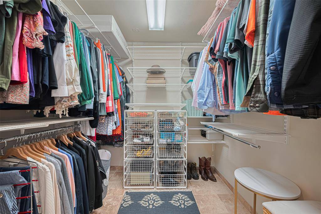 Primary walk-in closet has built ins to organize all your clothes and shoes