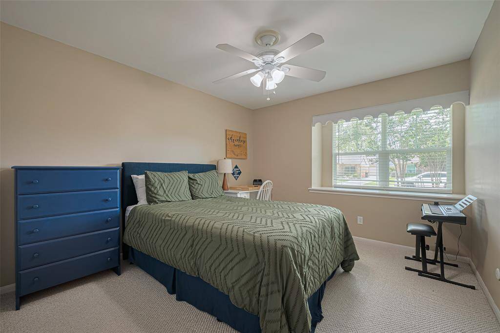 Third bedroom with deep window bench and scalloped wood trim staying true to the home era