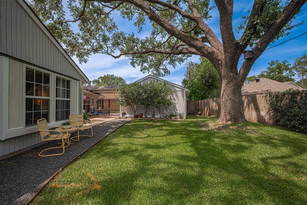Lush grass and additional seating in the shaded back yard. Fence was not replaced in this photo - new fence completed 5/16/25 so view in person!
