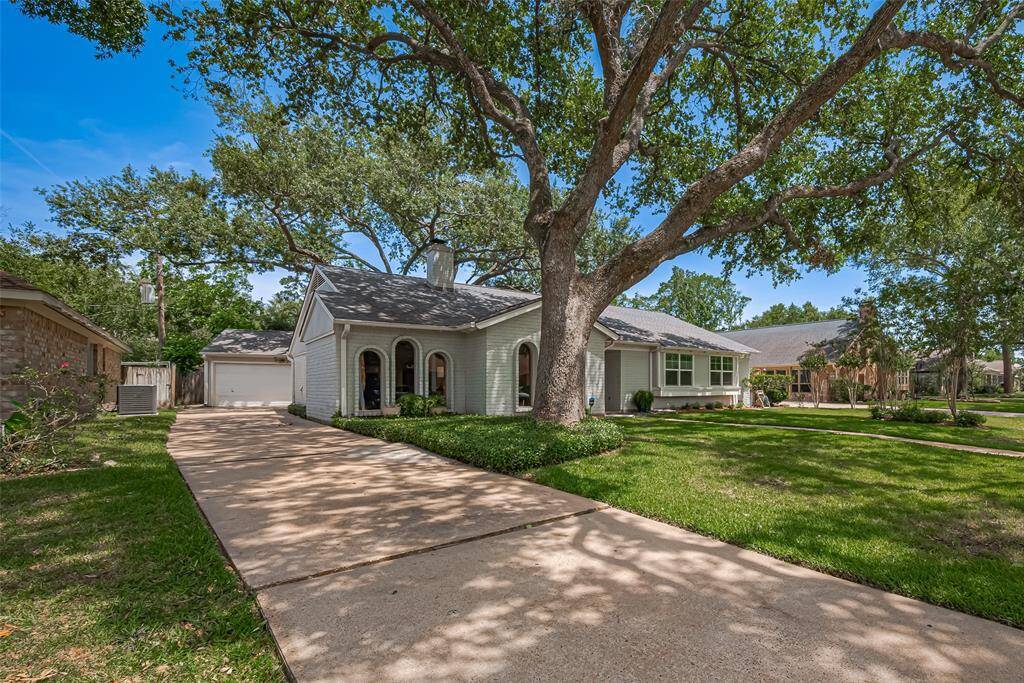 Driveway to double detached garage for entry to the private backyard. Enjoy your shade trees that have been maintained by an arborist for safety and maintenance
