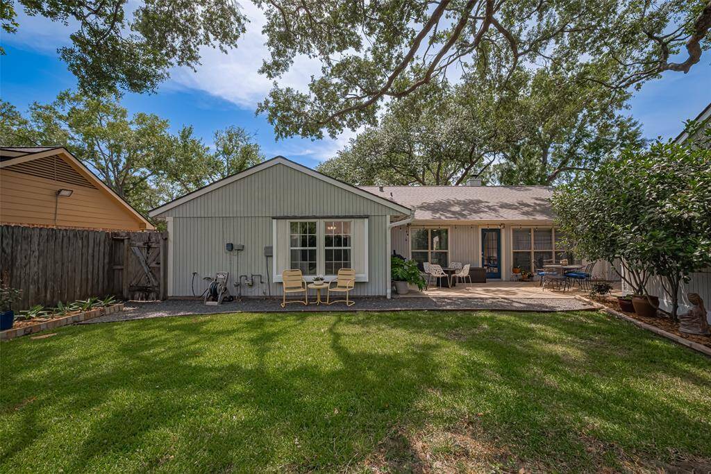 View from the back area to the home, new fence will be all completed 5/16/25. Enjoy your shady beautifully landscaped haven
