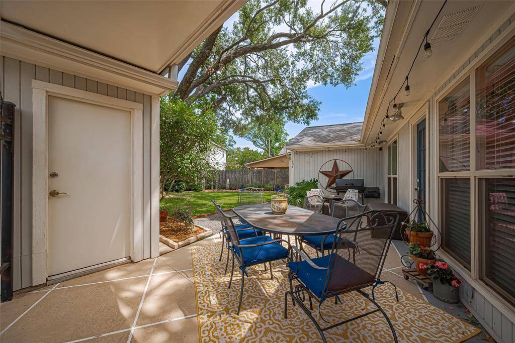 The perfect outdoor space for meals, and entertaining. There is a covering from home to garage so you will not get wet!