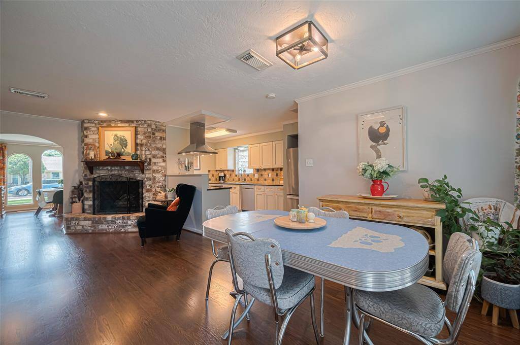 Great breakfast eating area open to the kitchen and beautiful feature fireplace. Stainless steel mount range hood hovers over the stove and additional counter space