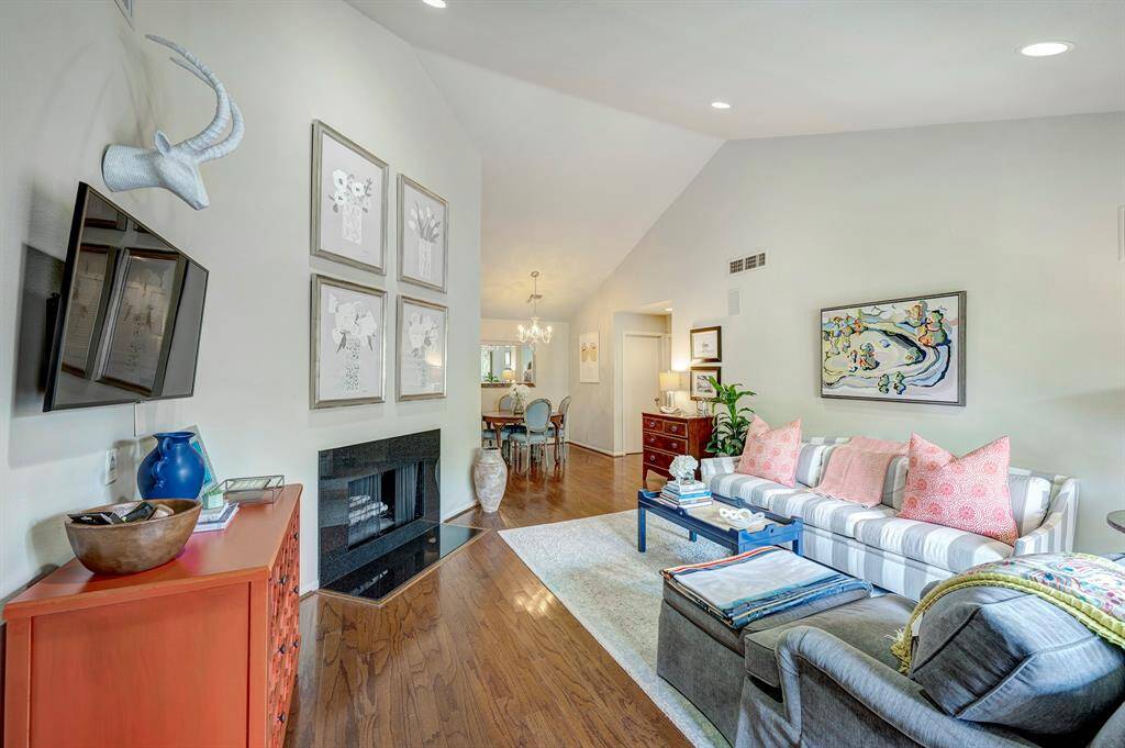 Living room is open to the dining room. Note the soaring vaulted ceilings and recessed lighting.