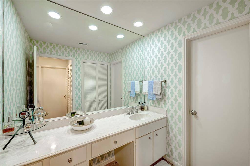 Primary bath features a separate vanity/sink area, with a tub/shower combo through the adjoining door.
