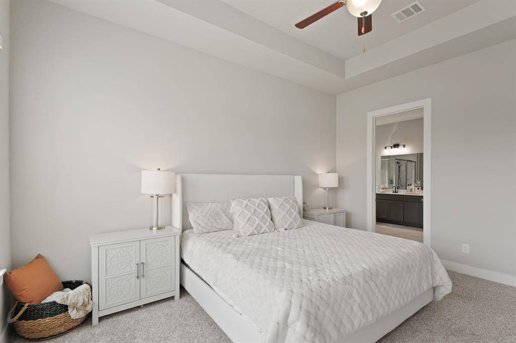 This serene bedroom retreat offers direct access to the en-suite bath, creating a seamless flow between rest and relaxation.