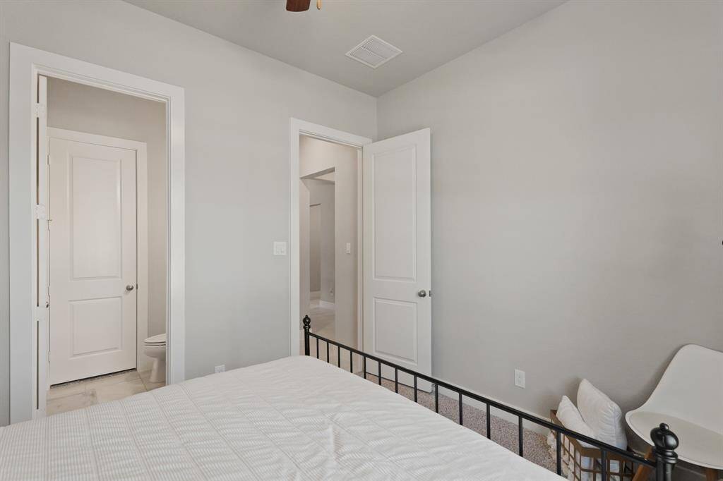 A convenient layout connects this spacious bedroom to a nearby full bathroom—ideal for guests or multigenerational living.