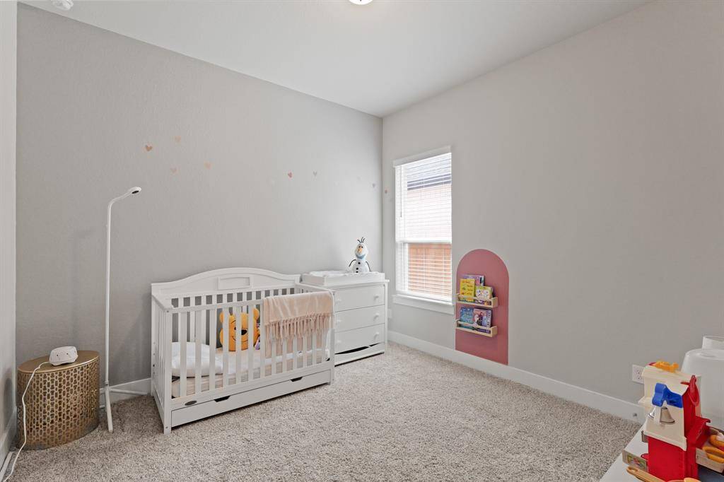 This light-filled secondary bedroom features neutral tones, plush carpet, and a spacious layout—ready to fit your unique style and needs.